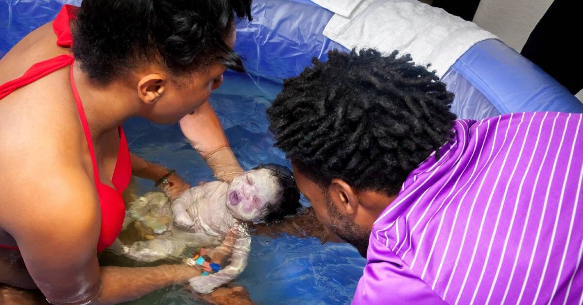 A Black couple welcoming a newborn baby into their lives after the mom gave birth at home in a birth pool.